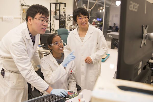 ASU engineer Ximin He with students in lab