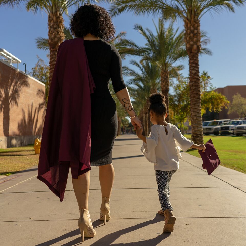 Soleil and her daughter Selena walk on Palm Walk