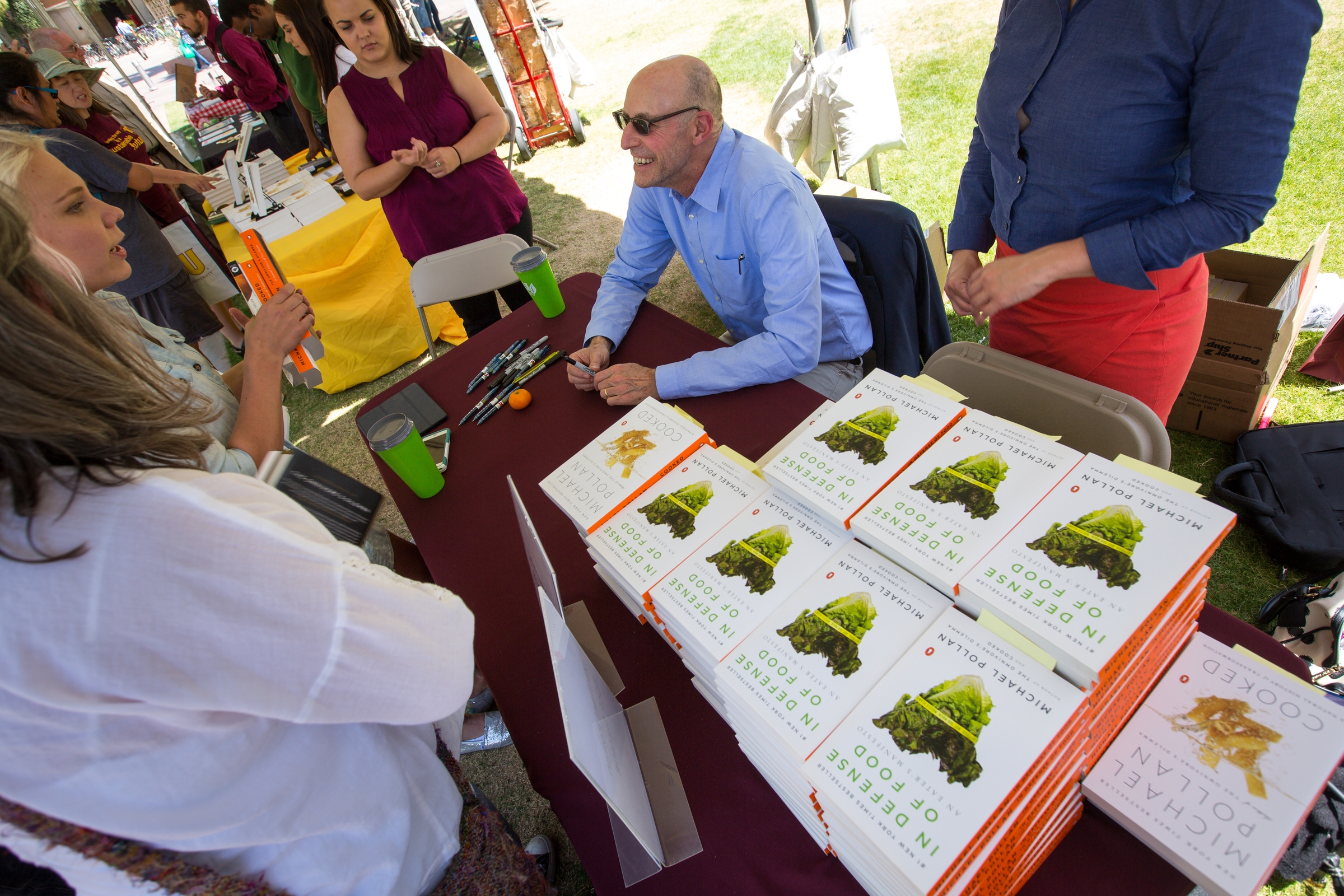 Michael Pollan signs books at the School of Sustainability picnic.