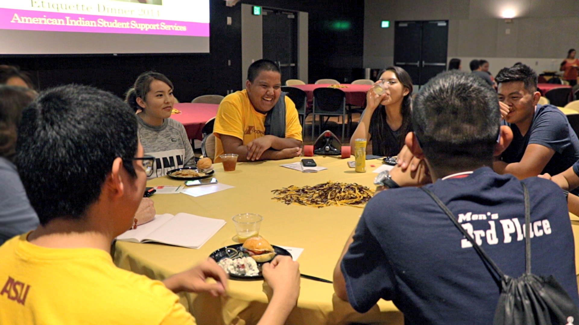 Students sit around a table talking during a SPIRIT event
