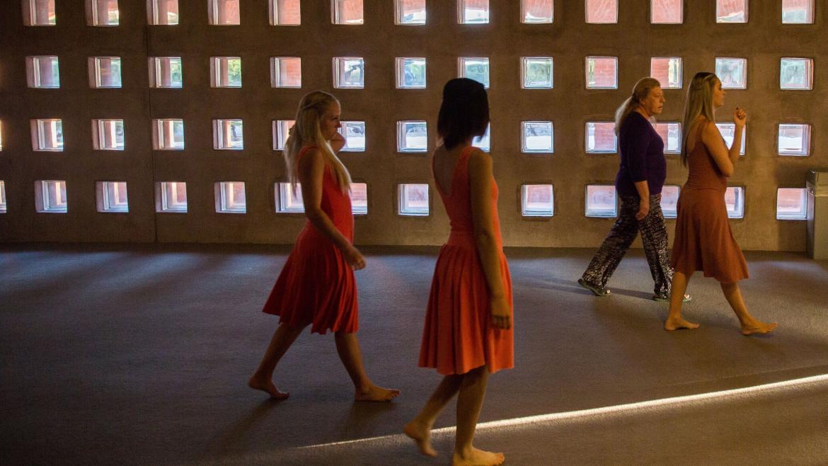 ASU dance students walk with costume-shop coordinator Jacqueline Benard to a rehearsal.