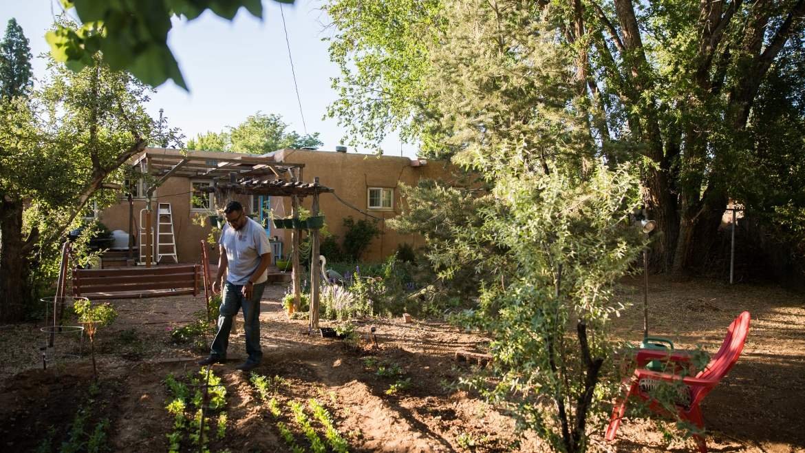 Carnell Chosa works in his garden in Santa Fe