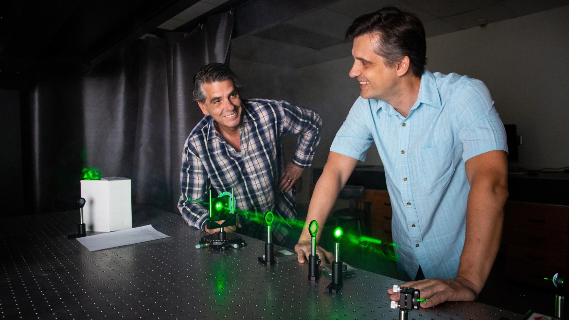 two men working on lasers in lab