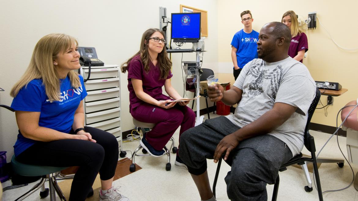 Medical personnel examine a man's hearing.