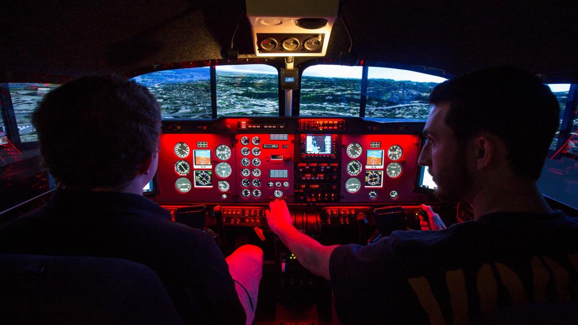 Aviation students in a flight simulator.