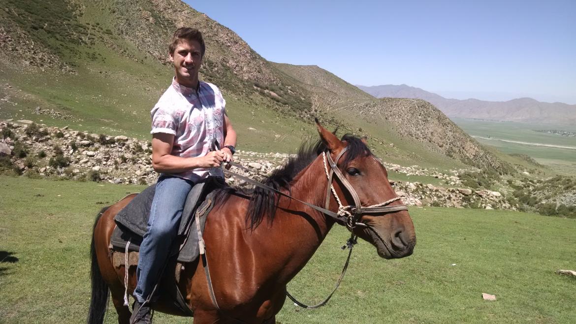 man on a horse near mountains