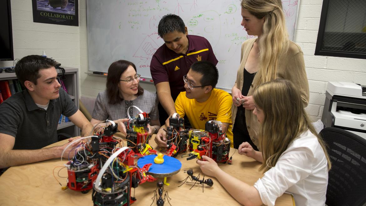 ASU engineer working with students on robots