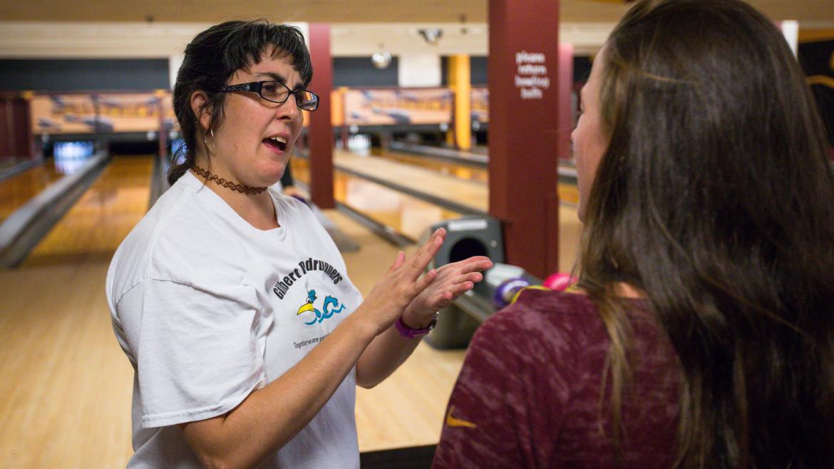 Special Olympian Sofija Obradovic, of Chandler, instructs one of the ASU student athletes on proper technique at Sparky's Den