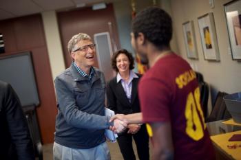 Bill Gates shakes hands with an ASU student