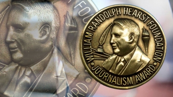 Close-up of the Hearst Award, a shiny, circular medallian featuring the bust of William Randolph Hearst.