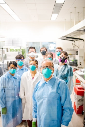 Scientists wearing personal protective equipment in the Biodesign Clinical Testing Laboratory at Arizona State University.