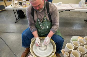Ehren Tool shapes a ceramic cup