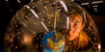 Person looking at a globe.