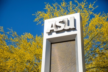 An ASU sign in front of paloverde trees in bloom