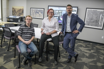 From left to right, Eric Friesenhahn, Jill Sherwood and Matthew Toro pose for a photo in the Map and Geospatial Hub with the Esri Special Achievement in GIS Award.