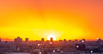 A city skyline against a sunset.
