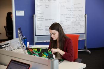 woman working on laptop in classroom