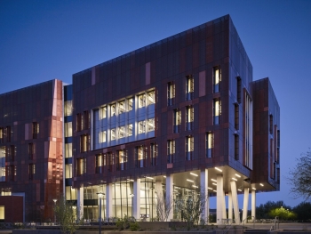 Exterior of the Biodesign Institute Building C pictured against a dark blue sky.