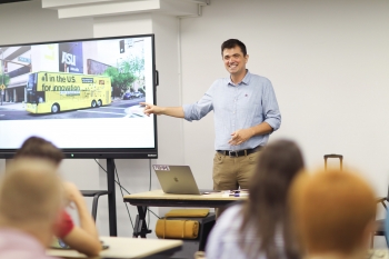 ASU Professor Visar Berisha gives a presentation to participants in a classroom.