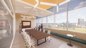 A digital rendering of a conference room with a long table and a screen on one wall. The view of downtown Phoenix can be seen from the window.