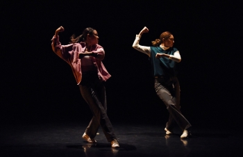 Two women dancing on a stage.