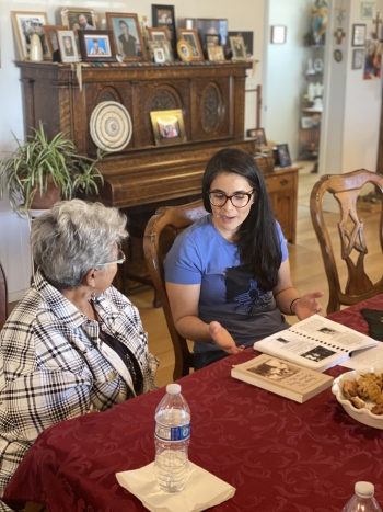 Older woman Angela Murphy seated at a dining table in her home in Concho, AZ, as she speaks with ASU Associate Professor Vanessa Fonseca-Chávez.