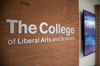 Sign on a brick wall that reads "The College of Liberal Arts and Sciences."