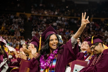 student at ASU Hispanic Convocation making a pitchfork with her hand