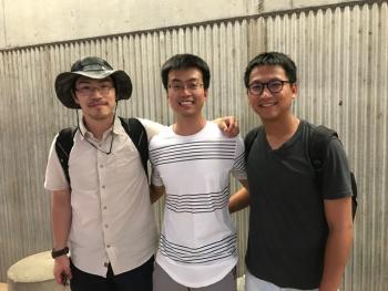 professor and two students standing in a row