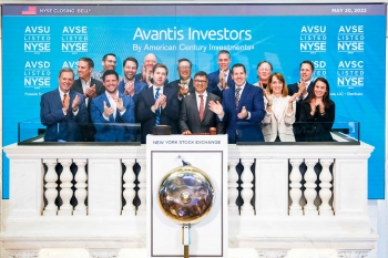 Group photo of people wearing business suits at a celebration for the launch of Avantis Investors four exchange-traded funds at the New York Stock Exchange.