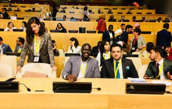 Bandak Lul seated next to youth delegate from Pakistan