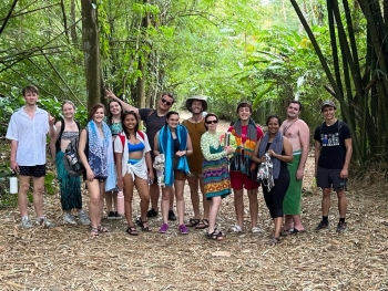 Barrett Honors College students posing as a group in a forest in Tobago