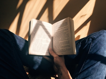 Stock photo of a person holding a book.