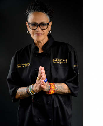 Portrait of Phoenix chef Silvana Salcido Esparza in a chef coat with hands pressed together.
