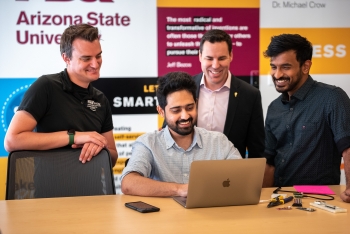 ASU students and Cloud Innovation Center interns working on a project at the CIC with ASU General Manager Ryan Hendrix.