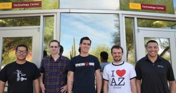 group photo of five ASU students in front of building