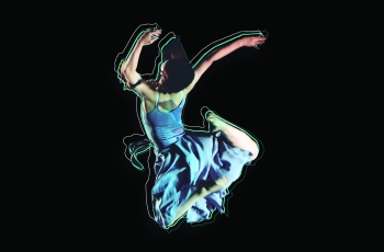 dancer in blue dress leaps into the air