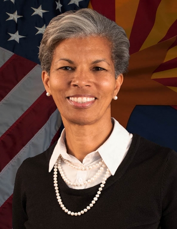 Retire Col. Wanda A. Wright portrait in front of partial view of U.S. and Arizona flags