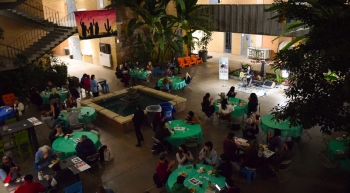 Aerial shot of Local to Global Justice event showing people sitting at tables inside an event hall.