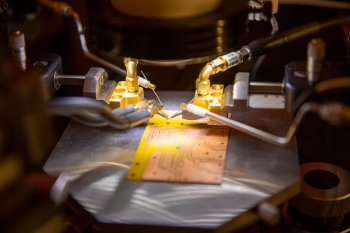 A semiconductor undergoes electrical testing in a lab.