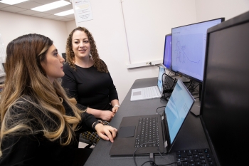 Electrical engineering doctoral student Zahra Soltani and Assistant Professor of electrical engineering Mojdeh Khorsand Hedman together in a computer lab.