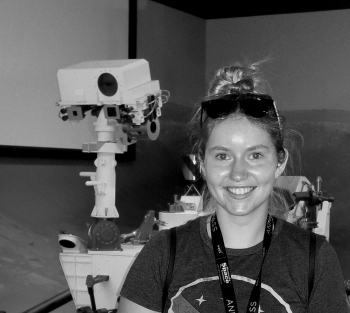 ASU graduate Emma Softich stands in front of a Mars rover.