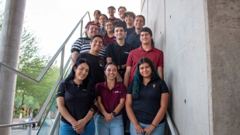Students of the ASU chapter of the Society of Hispanic Professional Engineers pose for a group photo on a staircase.