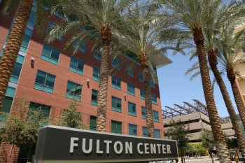 Exterior shot of ASU building with a sign that reads "Fulton Center" and palm trees.