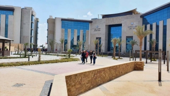 A small group of students walk together in front of the Faculty of Medical Sciences building on the Galala University campus in Suez, Egypt.