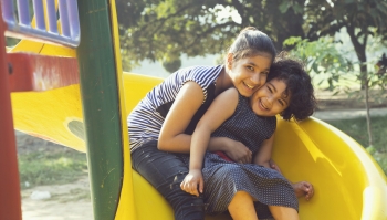 two girls on a slide