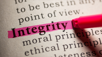 Close-up photo of words on paper, with the word "Integrity" being highlighted in pink.