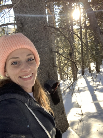 ASU Online student Hayley Rose posing for a selfie in a wooded, snowy area while wearing a jacket and beanie.