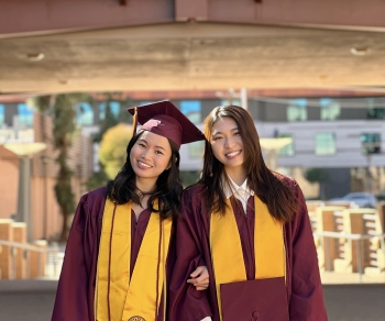 ASU students Meng Jye Lin and Abbie Cheng wearing graduation regalia.