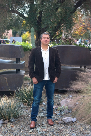 Francisco Pedraza, Arizona State University associate professor in the School of Politics and Global Studies, wearing jeans and a blazer outside on the Tempe campus.